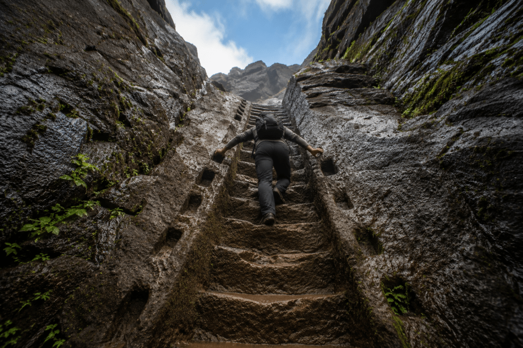 Looking up the 70-degree rock-cut staircase at Harihar Fort - Maharashtra Fort Trek Guide 2026